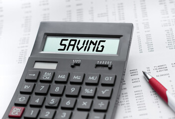 A calculator with the inscription SAVING . Business profit concept