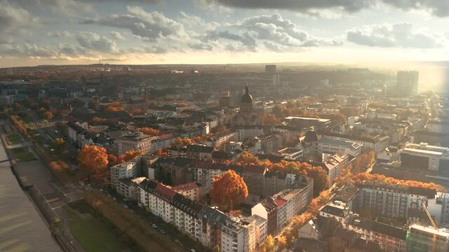 Drone shot of Mainz the City of Biontech vaccine against Corona Covid 19 in Germany from an aerial view in golden fall mood and dramatic Sky showing the Christus Kirche in Neustadt city part