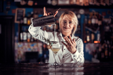 Girl barman concocts a cocktail on the porterhouse