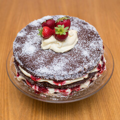 chocolate cake with cream and strawberries