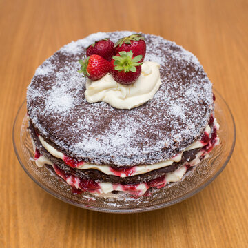 chocolate cake with cream and strawberries