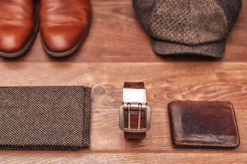 Men's clothing and accessories on a wooden background in warm colors