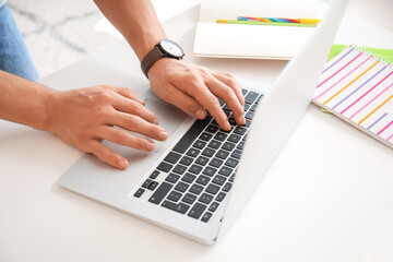 Young man working on laptop in office