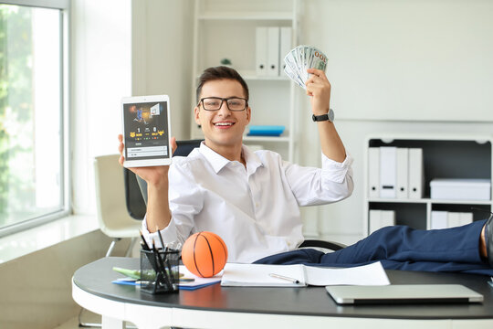 Young businessman placing sports bet in office
