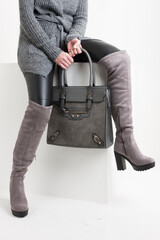 gray women's boots with a handbag