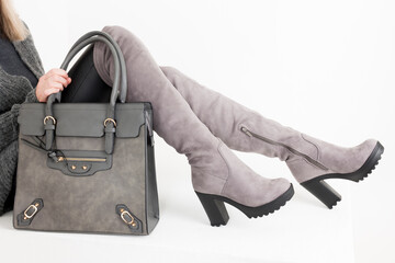 gray women's boots with a handbag