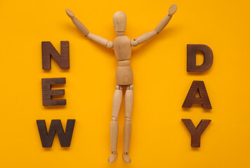 Wooden mannequin with text NEW DAY on color background