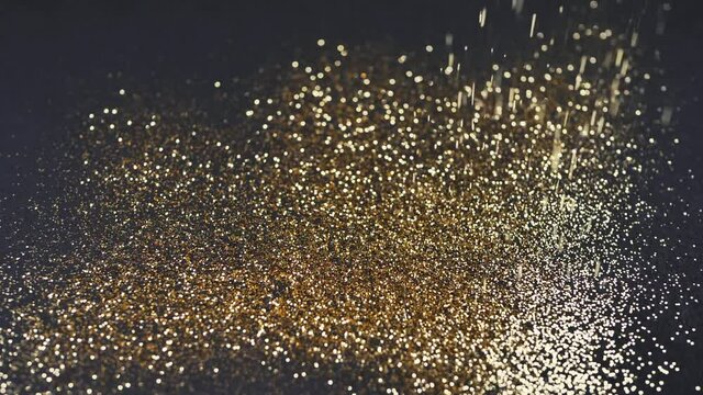 Gold dust falls on a black background