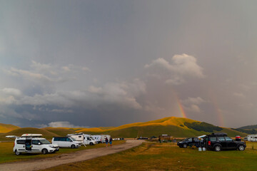 Vanlife in mountain landscape near Castelluccio village in National Park Monte Sibillini, Umbria region, Italy