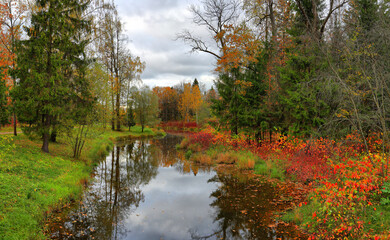 Autumn landscape with a river on a cloudy day