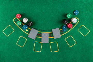 Chips cards lie on a green blackjack table top view. Casino concept, gambling.