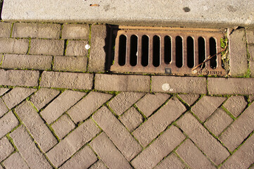 Closeup of a rain  drainage grid in the street