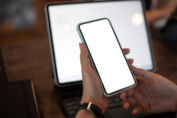 Mock up. image of woman holding mobile phone with blank white screen.