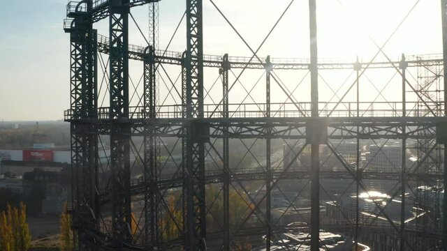 Close up of old abandones Gas holder or Gasometer in Berlin, Germany with Cityscape in beautiful Autumn Sunset