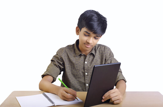 Indian Boy Using Digital Tablet While Attending The Online Classes At Home	
