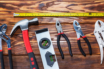 Close up tools on a wooden background.