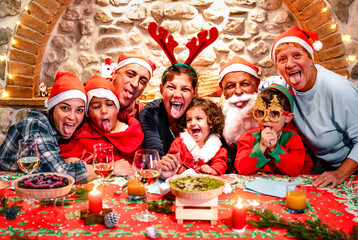 Funny selfie pic of multi generation large family with santa hats having fun at Christmas fest...