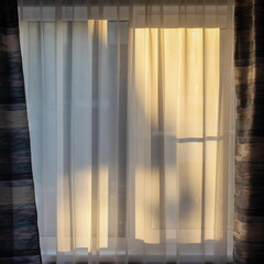 Evening outside the window with curtains