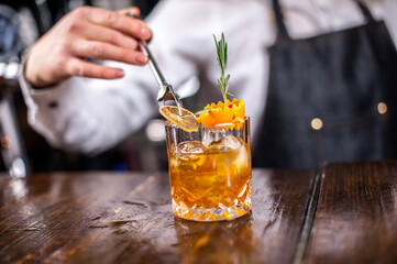 Girl barman concocts a cocktail at the pothouse