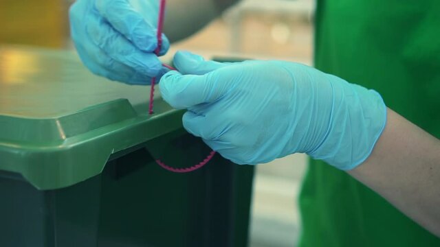Man worker tighten nylon tie on box. Spbd warehouse employee use plastic cable to close box. Put strap. Concept of fastener, lock, industrial. Equipment safety.