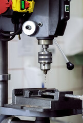 Vertical drilling machine for drilling holes in metal parts close-up.Equipment for Metalworking.High-tech production process