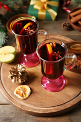 Glass cups of tasty mulled wine on table