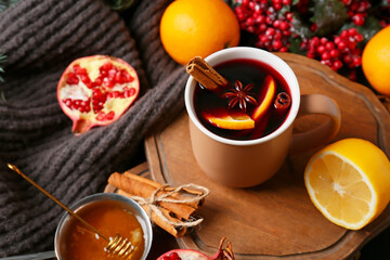 Cup of tasty mulled wine on table