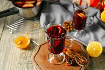 Glass cup of tasty mulled wine on table
