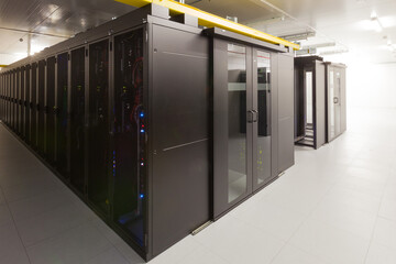 Network servers in a data center. Tier III carrier neutral data center. Server rooms.