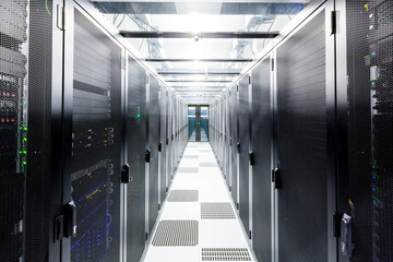 Network servers in a data center. Tier III carrier neutral data center. Server rooms.