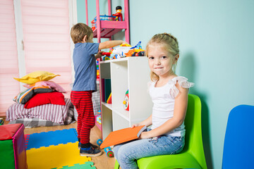 The happy kids play and develop in the kindergarten