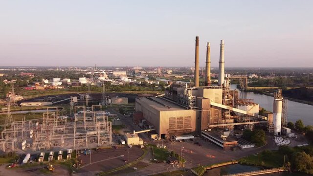 Drone Flying Towards DTE Rouge River Coal Powerplant In Michigan On A Sunny Morning - aerial