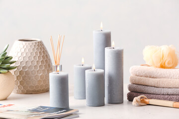 Fototapeta na wymiar Beautiful aroma candles on table in bathroom