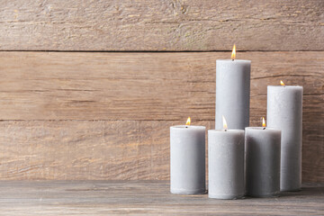 Beautiful aroma candles on wooden background