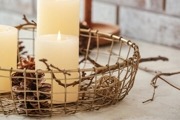 Obraz premium Beautiful aroma candles with cones on table in room