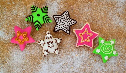 Christmas composition: star-shaped cookies on a wooden background and powdered sugar