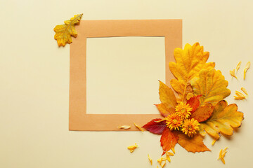 Naklejka na ściany i meble Frame and autumn leaves on light background