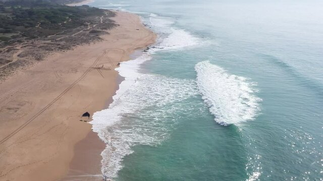 Waves breaking on the shore of the sandy beach of Mangueta, in Zahora town, south Spain