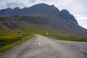 winding empty road to the tunnel, nature of Iceland