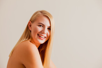 The young female model with bare shoulder is posing at the camera