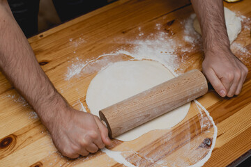 person kneading dough