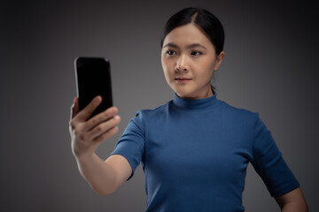 Asian woman scans face by smart phone using facial recognition system.