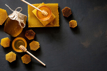 Healthy Thick honey dipping from the wooden honey spoon, bee products by organic natural...