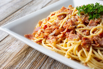 A view of a plate of spaghetti carbonara.