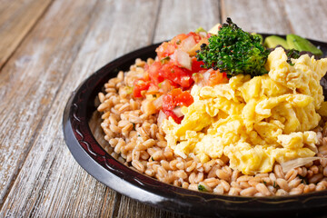 A view of a breakfast grain plate, featuring farro and scrambled eggs.