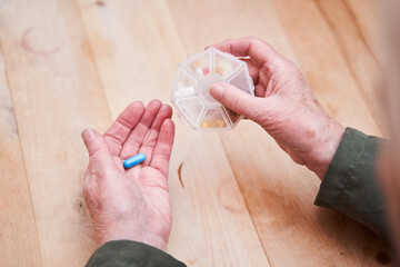 Woman getting out pill from the pill box