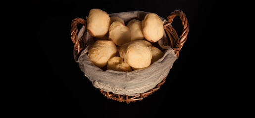 Brazilian cheese bread 'pao de queijo' on basket, homemade cheese buns. typical snack from minas gerais. Black Background