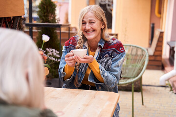 Woman laughing out loud while spending time with her senior mother