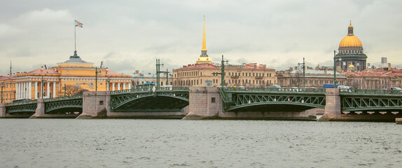 View of the Palace bridge, the Admiralty spire and the dome of St. Isaac's Cathedral from the right Bank of the Neva river.