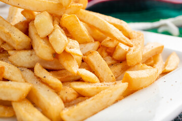 A closeup view of a plate of french fries.